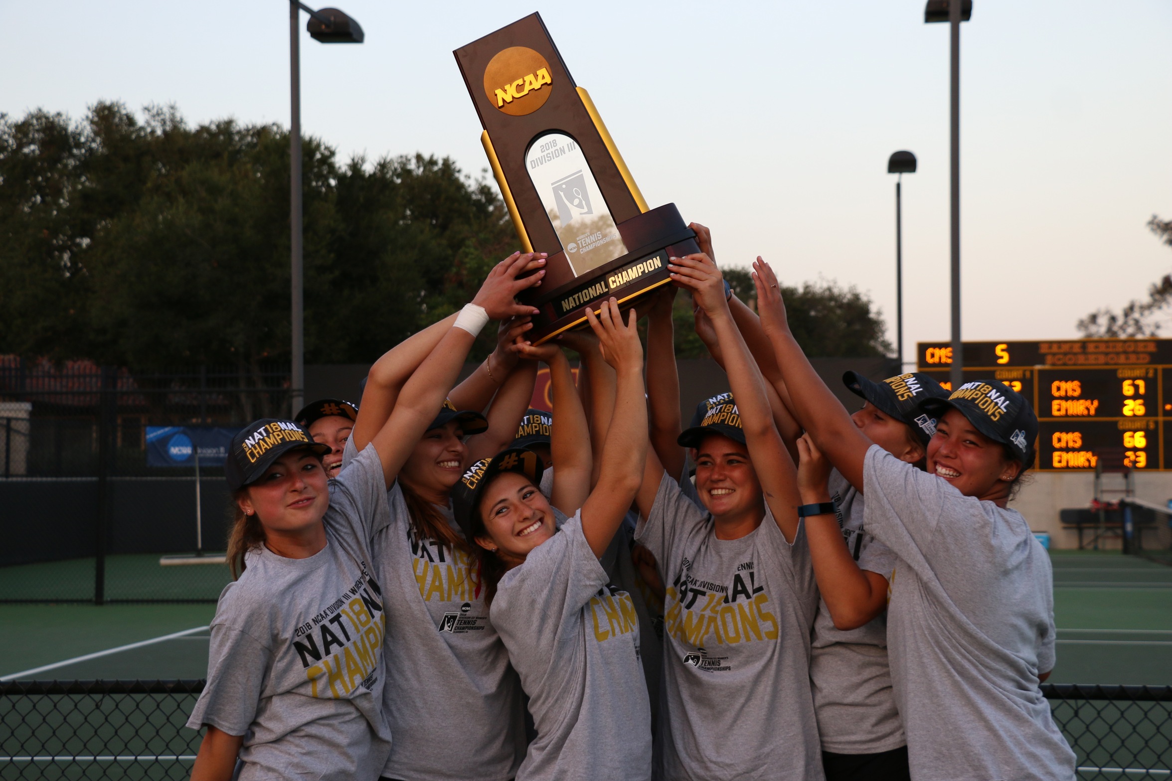 The 2018 women's tennis team holds the national trophy aloft