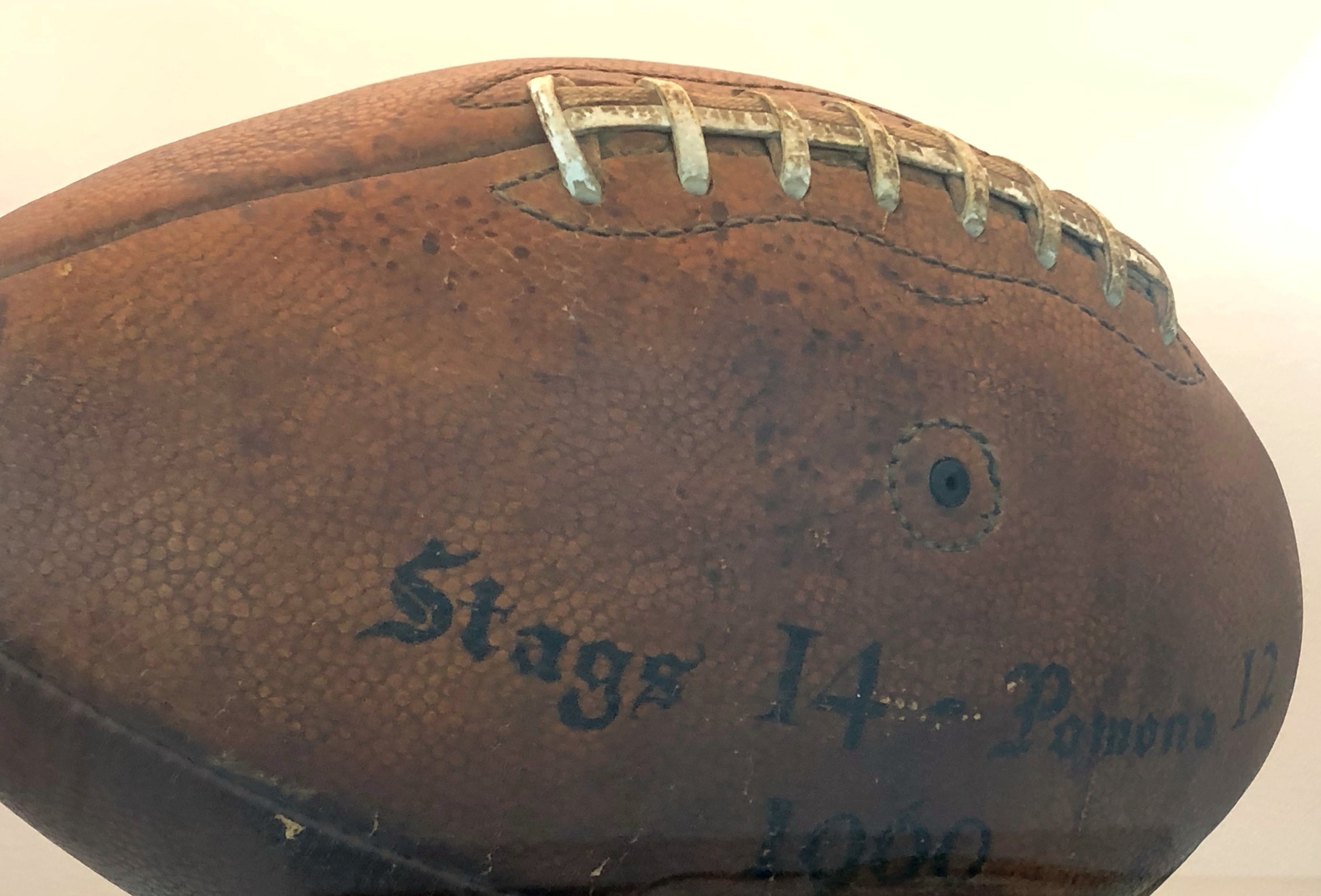 Game ball from the 1960 Pomona game with the final score written on it: Stags 14, Pomona 12