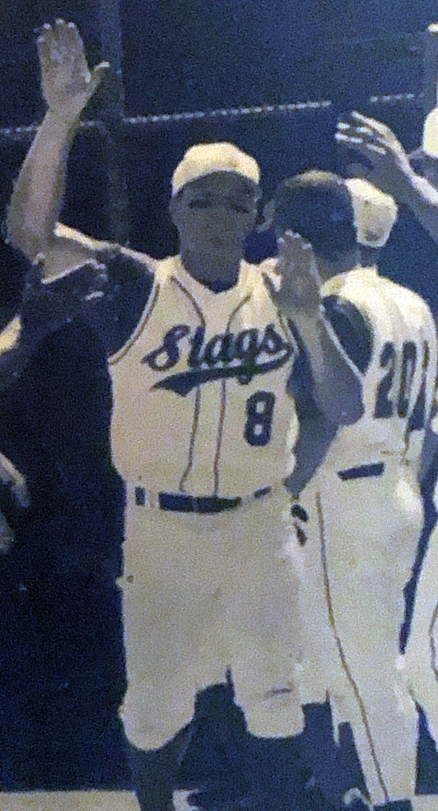 Tyler Laughery high-fiving in the dugout