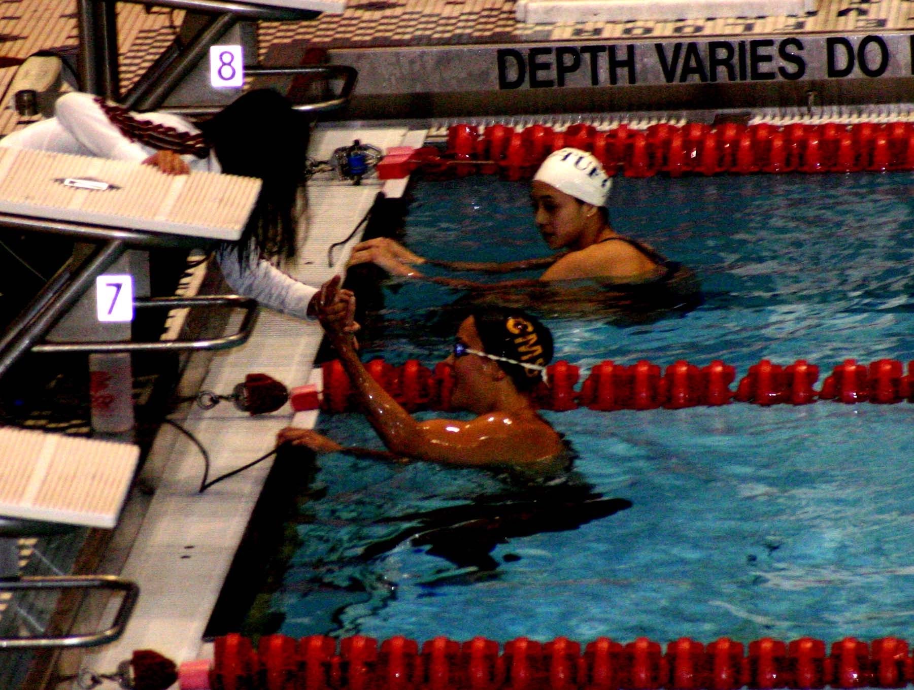Lisal Smith high-fiving Linh Luong after winning the 400 IM