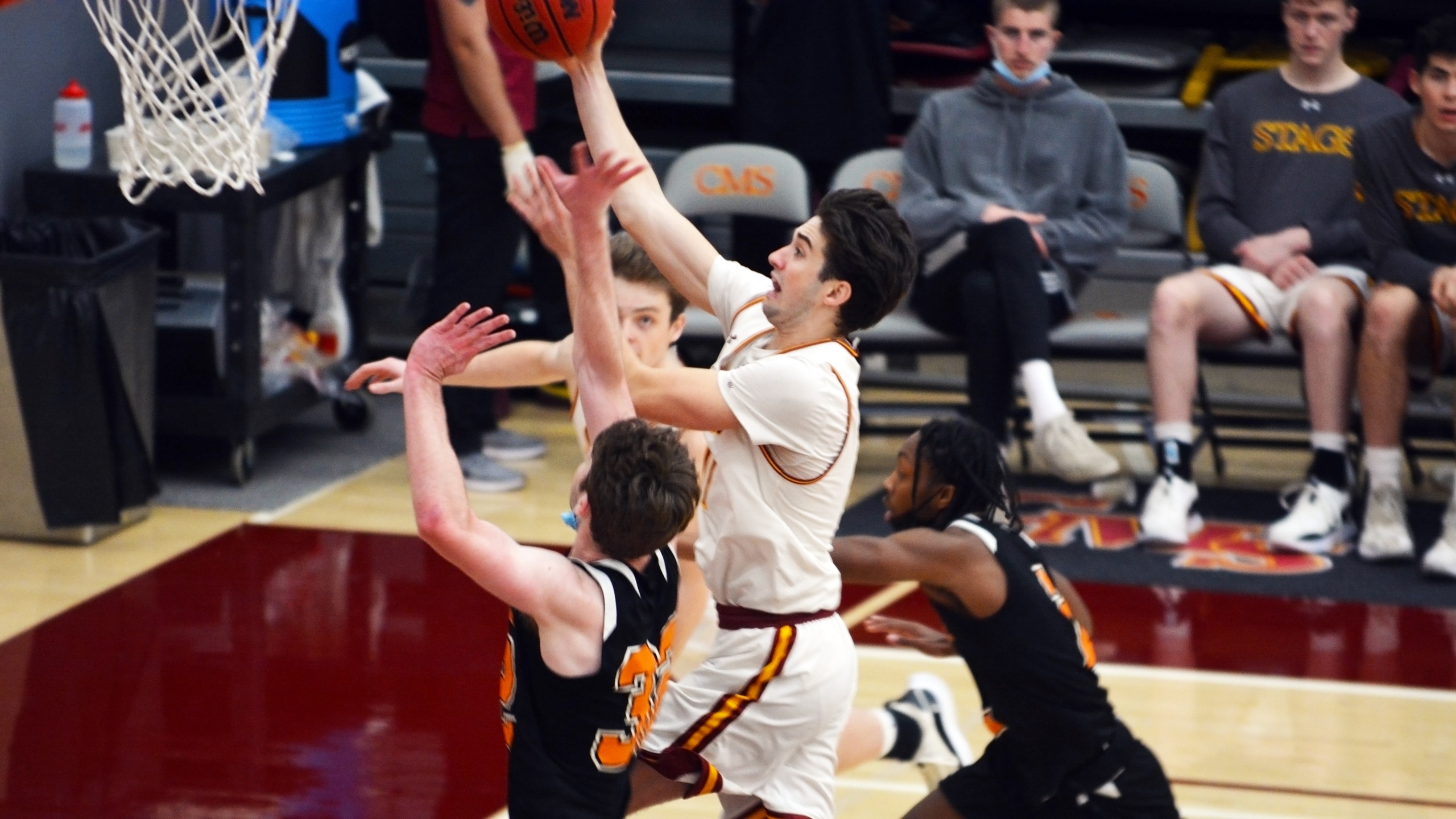 TJ Askew drives to the basket for a lay-up against Occidental.