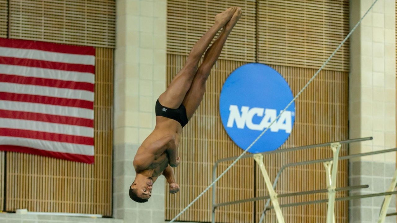 Kendall Hollimon diving at the NCAA Regionals with an NCAA logo on the wall in the background