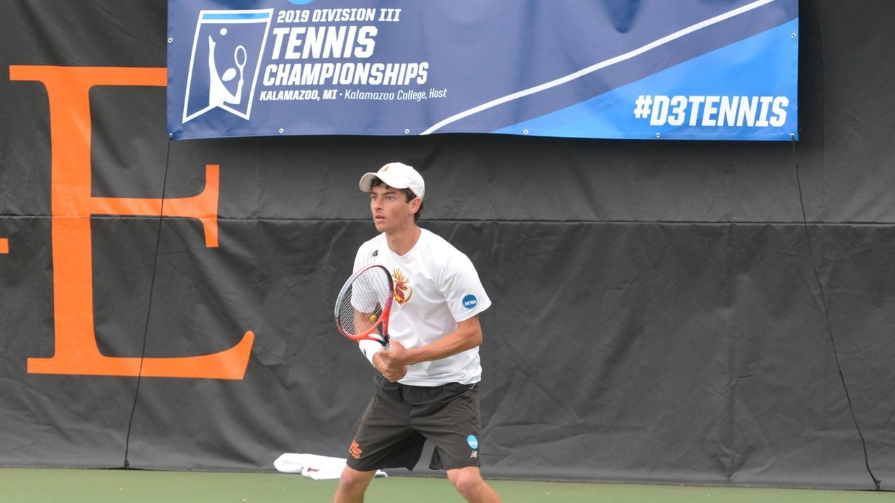 Jack Katzman in action at the NCAA Championships with an NCAA championship banner on the fence behind him