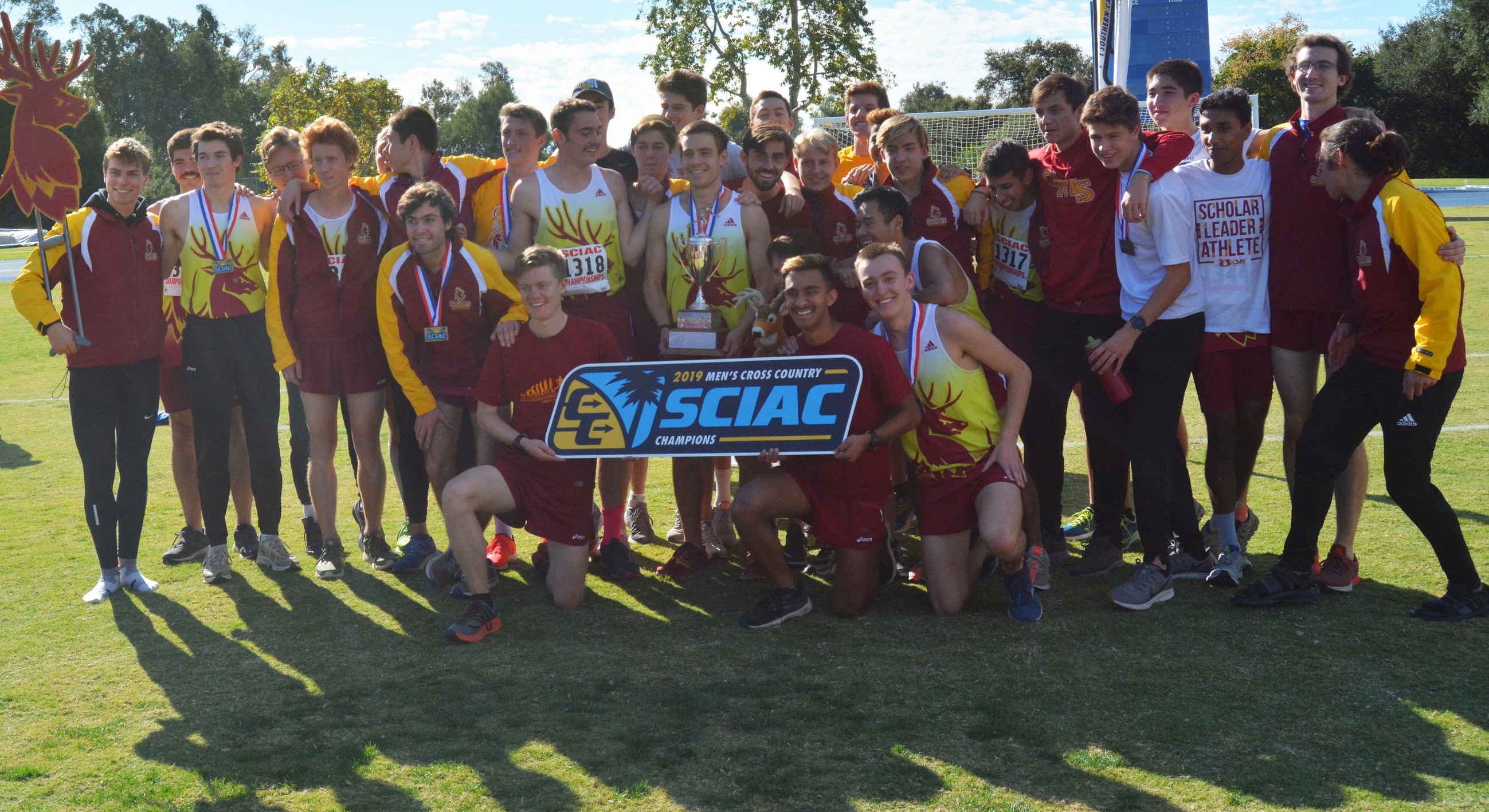 CMS men's cross country celebrating the SCIAC title
