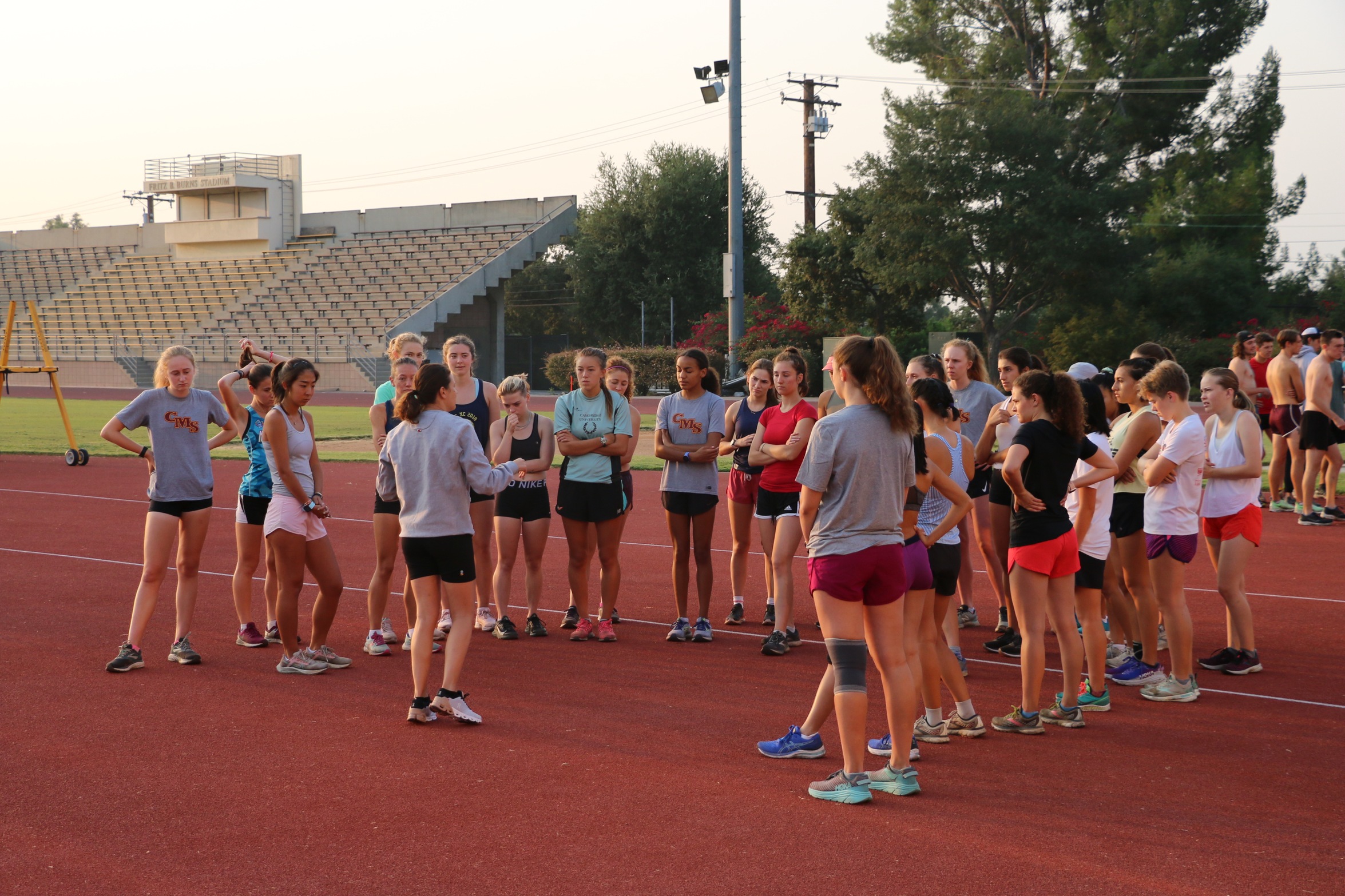 CMS women's cross country team huddle before a practice