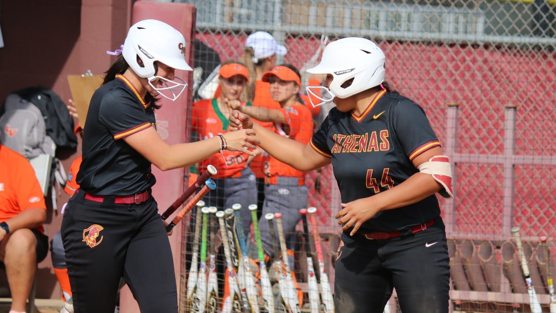 Paige Zimmerman and Abby Thompson celebrate Thompson's homer