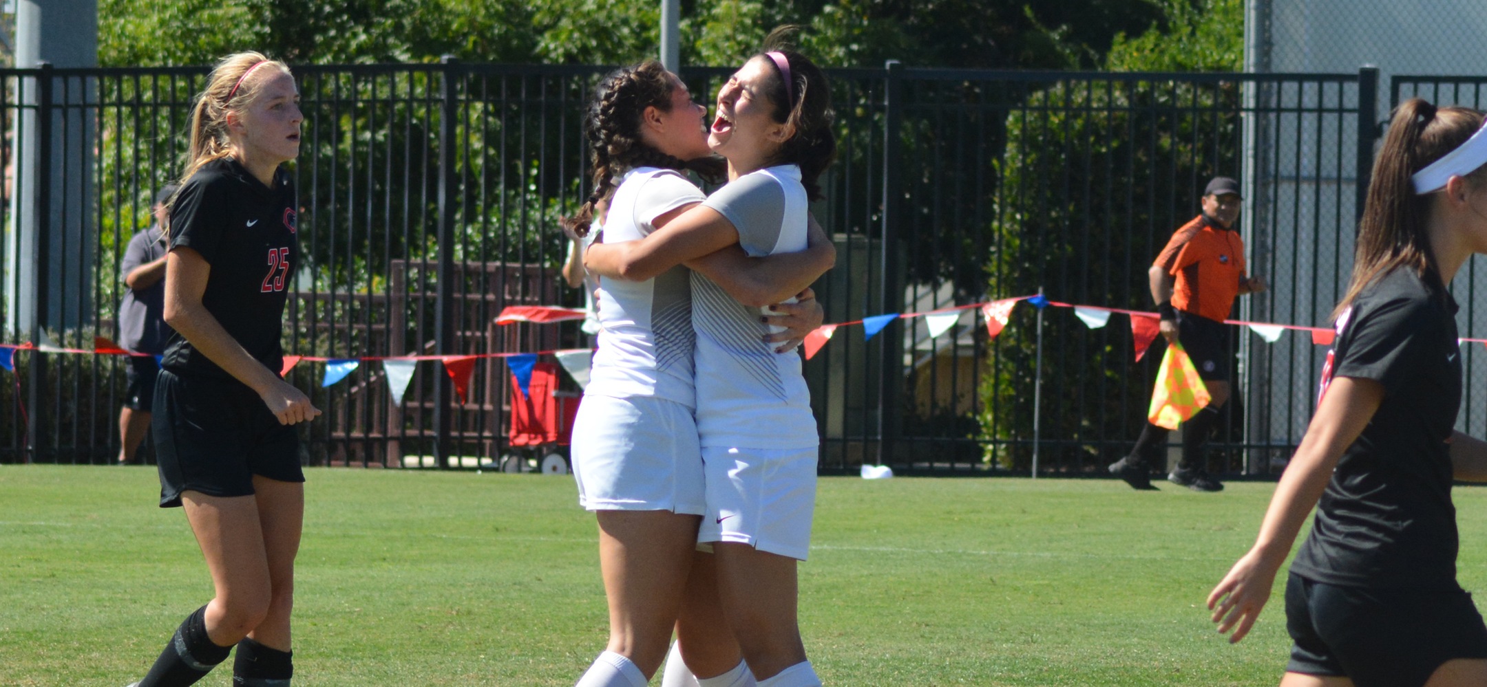 Kira Favakeh (L) and Sarah Tocher celebrate the winning goal (photo by Tessa Guerra)