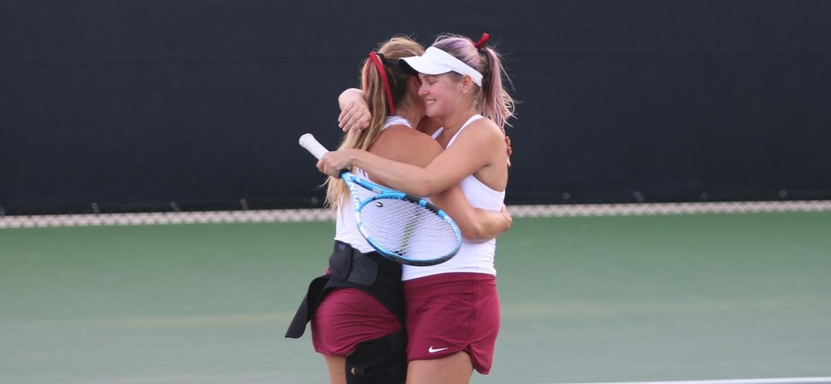 Catherine Allen and Caroline Cox celebrate their doubles win