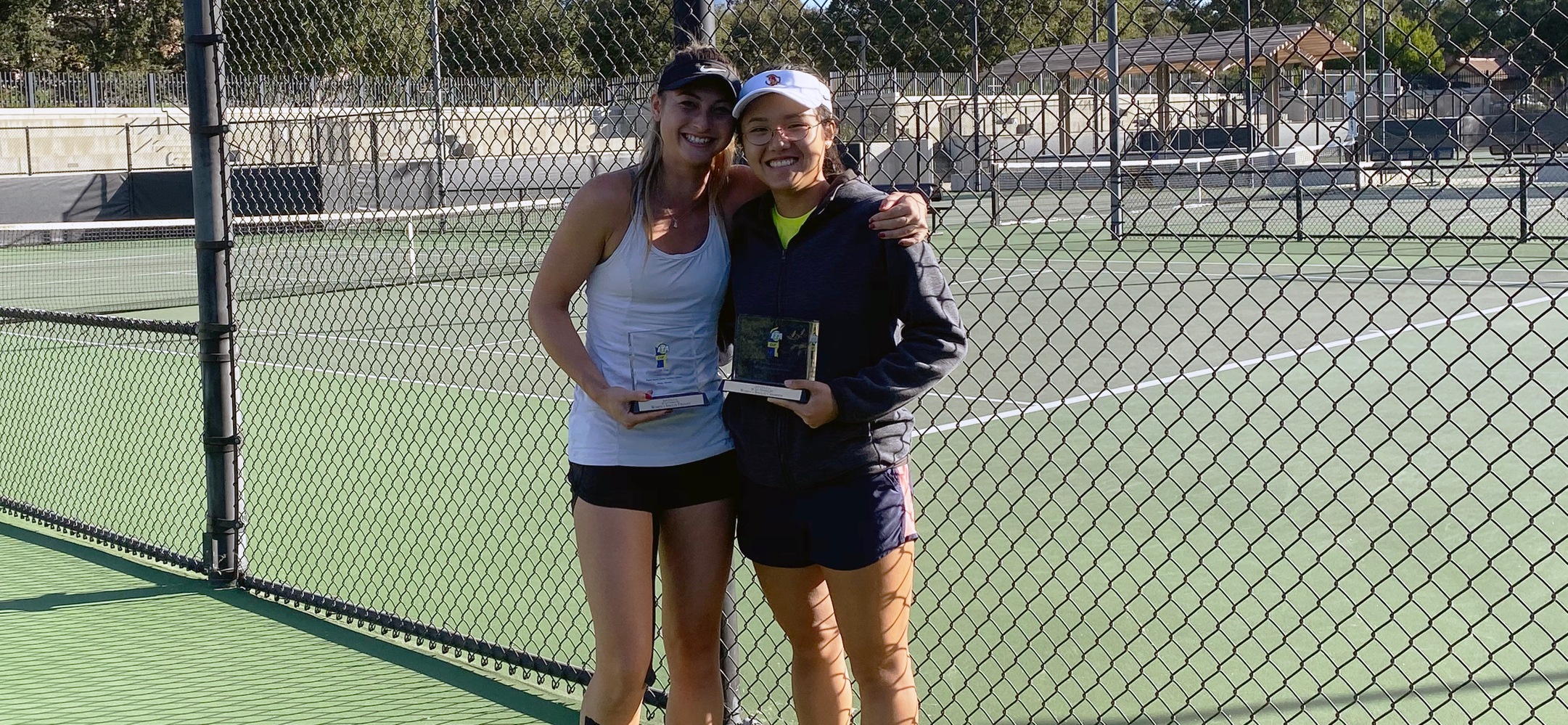 Catherine Allen (L) and Justine Leong (R) receive their ITA Cup singles runner-up and championship plaques in Claremont