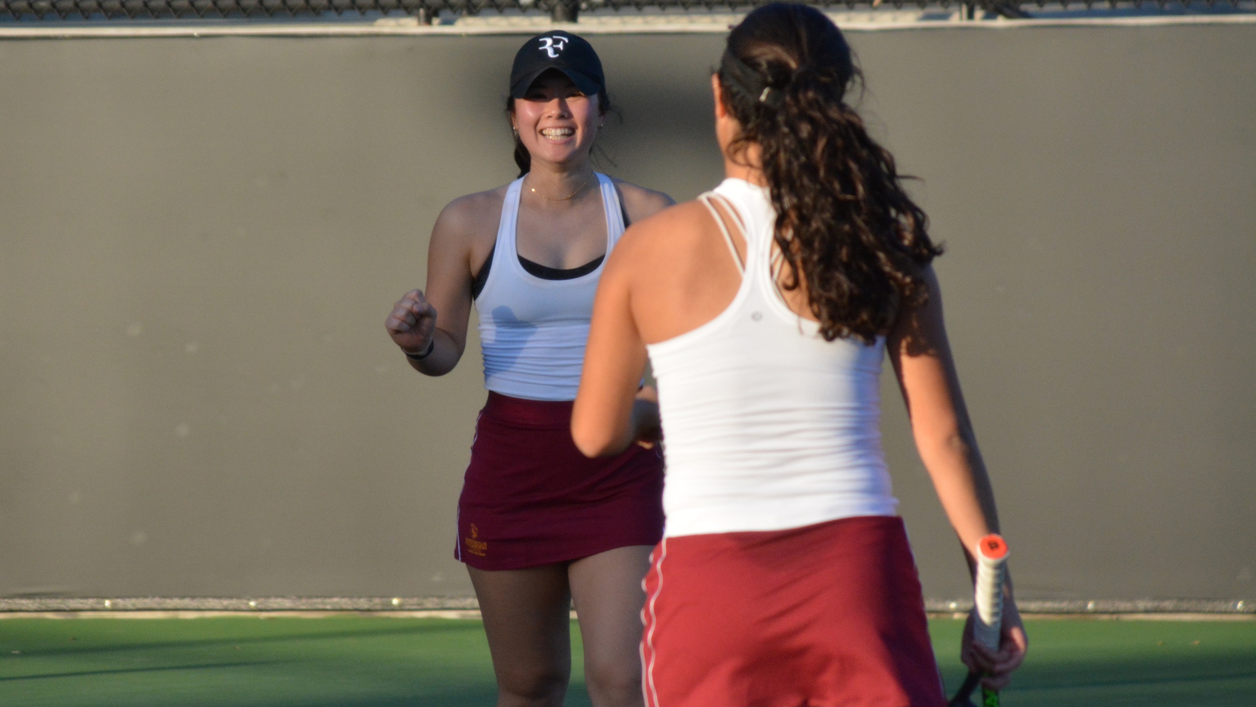 Sena Selby and Sarah Bahsoun celebrate a late point in their doubles win