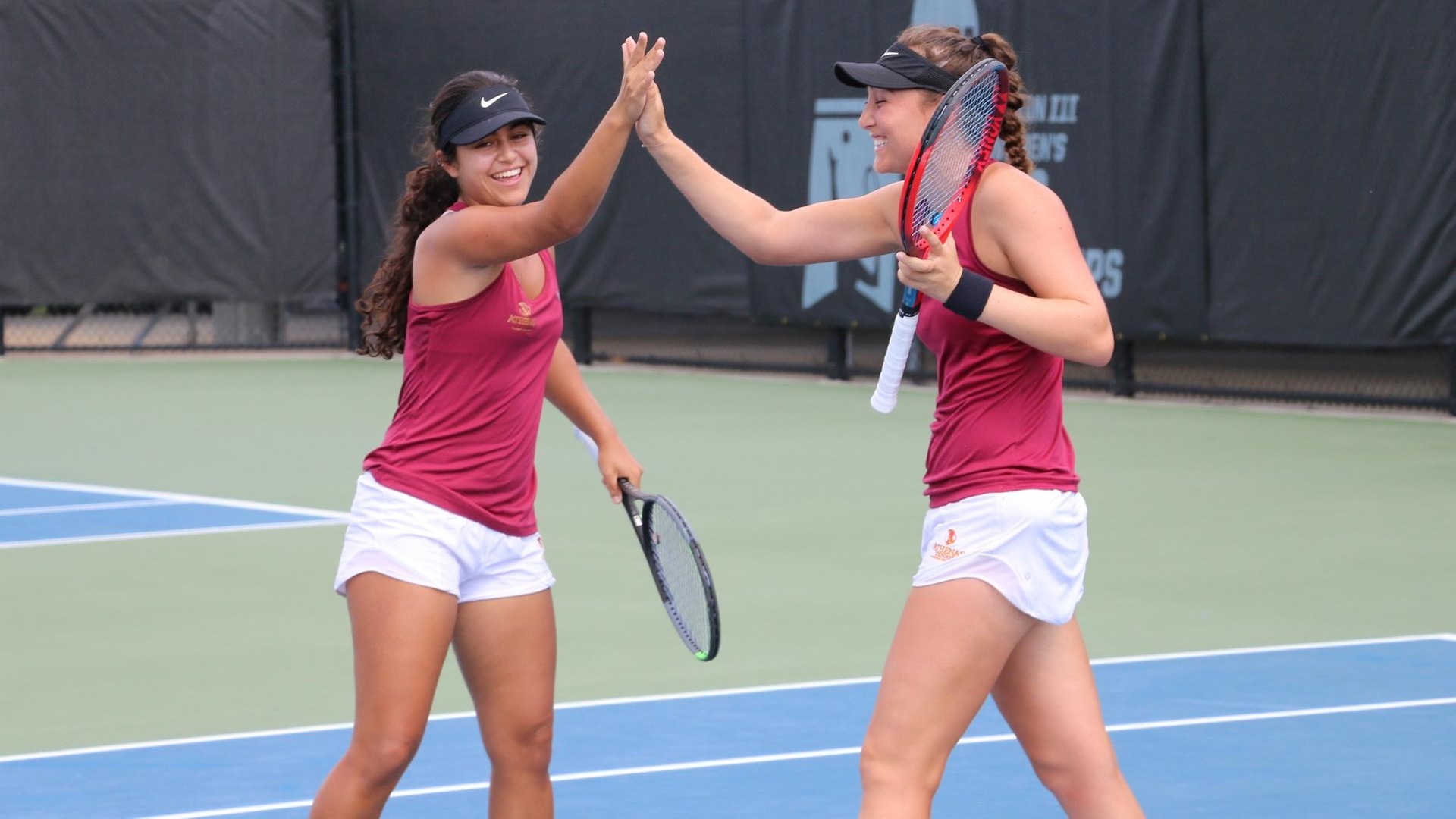 Sarah Bahsoun and Devon Wolfe celebrate a point on their way to an 8-1 win