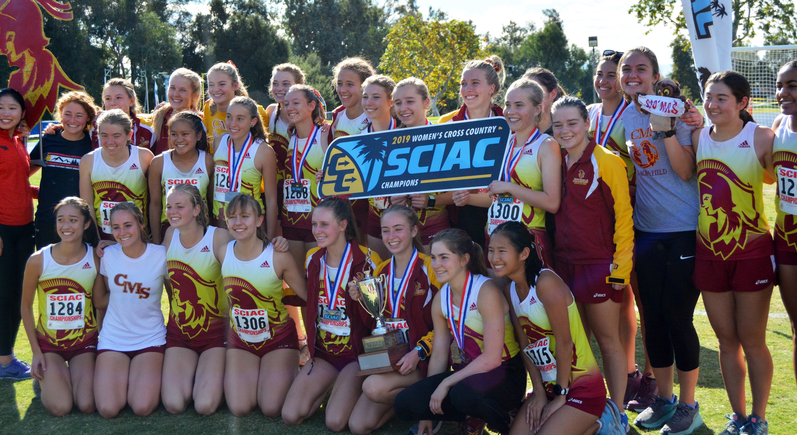 The 2019 women's cross country team celebrates the SCIAC title